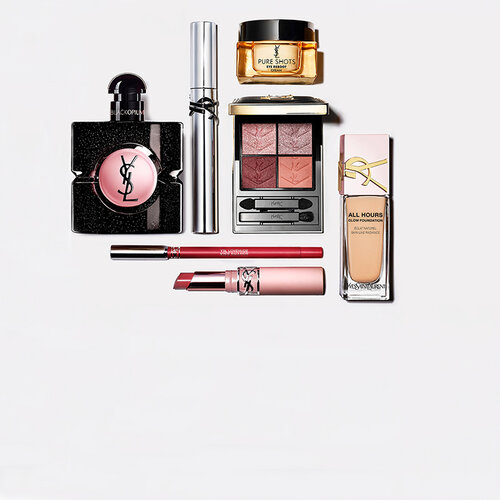 YSL beautyproducten waaronder een doorgestikt compactpoeder, mascara en twee lipsticks tegen een glanzende roze tegelachtergrond.