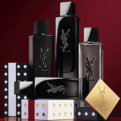 Yves Saint Laurent kerstcollectie cadeausets en luxe schoonheidsproducten tegen een feestelijke rode achtergrond.