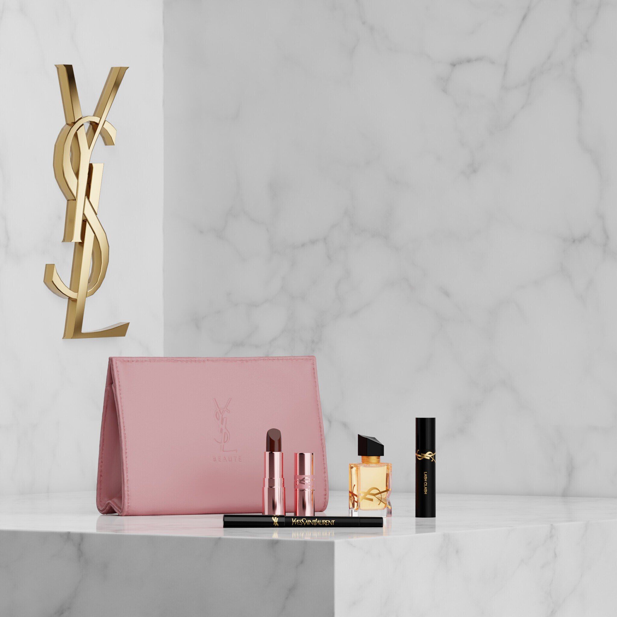 YSL Beauty-set met roze etui, lipstick, eyeliner, mascara en mini parfum op een marmeren plank.