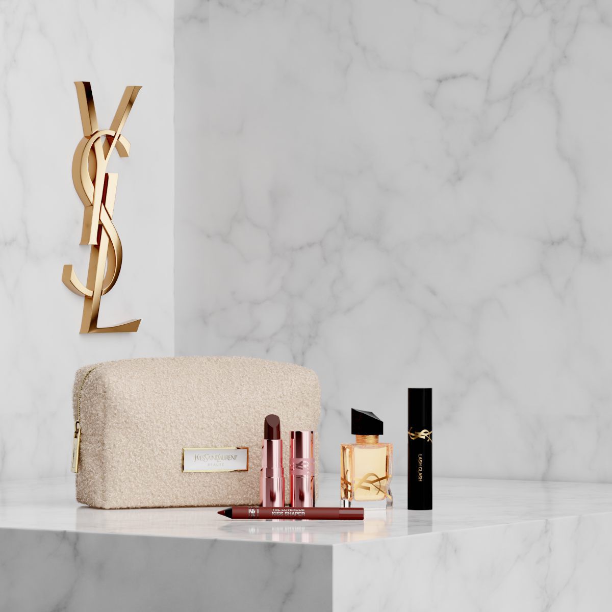 Pouch, Libre parfum en YSL make-up op een witte marmeren achtergrond.