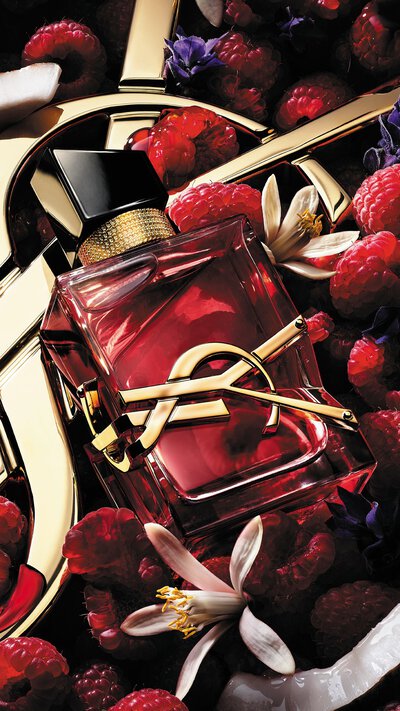YSL Libre bottle with raspberries, creamy coconut, jasmine flowers, and lavender accents.
