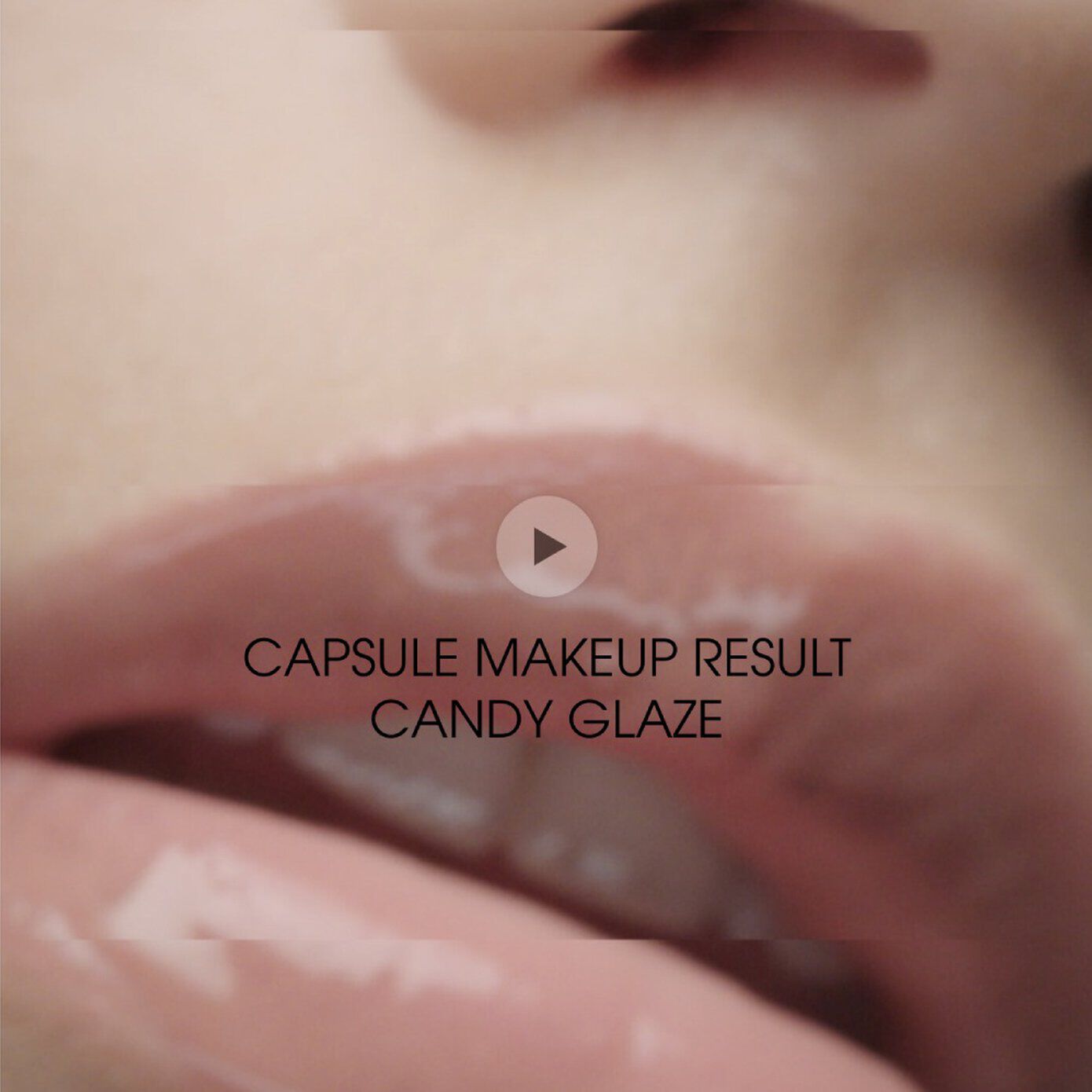 Close-up of glossy, soft pink lips with a caption that reads "CAPSULE MAKEUP RESULT CANDY GLAZE" along with a play button icon.