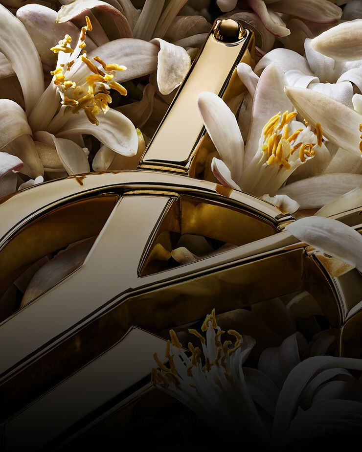 Gouden YSL Cassandre met witte oranjebloesems.