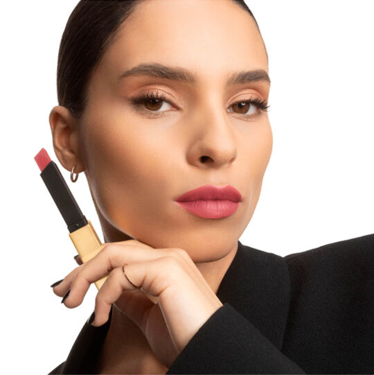 Twee handen tonen YSL-lipsticks met vierkante punt, één open en één gesloten.