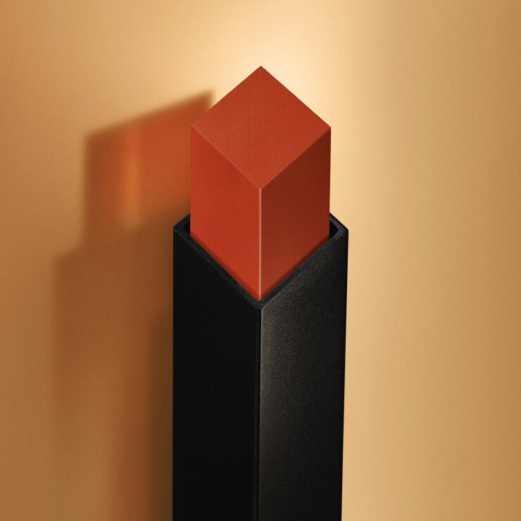 Close-up van koraalkleurige lippen met vierkante lipstickpunt.